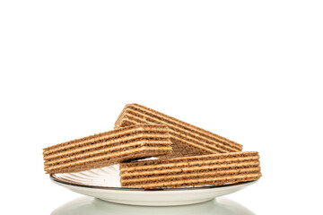 Sweet waffles on a ceramic saucer, close-up, isolated on a white background.