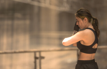 Confident and strong female Asian Muay Thai boxer practice Thai boxing 