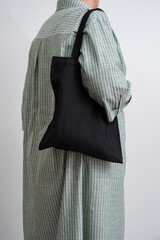 woman holding black reusable Shopper. Eco-friendliness in everyday life