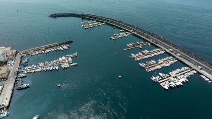 Aerial view of the port of the city of Torre del Greco in the province of Naples, Campania, Italy. There are many boats anchored in the marina.