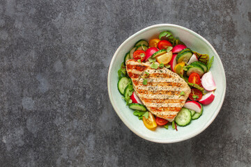 Juicy pork steak grill with vegetables in a plate on the table. Top view