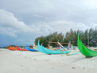 Colorful boats on the beach. Kater boat, the colorful outrigger fishing boat on the beach at Manggar, East Belitung, Indonesia.