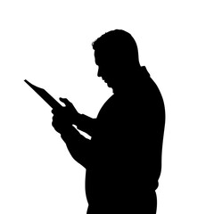 Man reading a document while standing in silhouette against light  