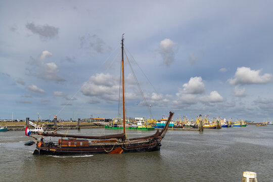 Traditional dutch sailing ship navigating Lauwersoog harbor in Groningen, Netherlands