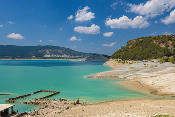 Yesa reservoir showing low water level revealing ruins of old town of Sigues, Spain