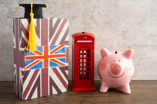 UK flag with graduate hat on english language book.