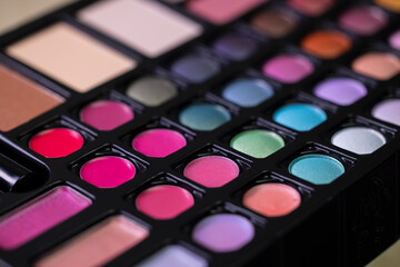 Colorful makeup palette showing variety of lipsticks and eyeshadows
