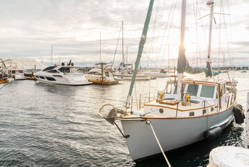 Luxury Yachts in a marina under cloudy sky at sunset in autumn