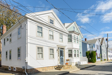 Traditional wooden town houses along a street in a historic downtown district in Connecticut on a sunny autumn day