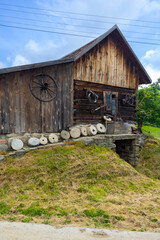 Old wooden watermill building with millstones in Sekowa, Poland, showcasing rural heritage