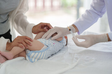 Doctors are gently vaccinating a boy in a clinic to ensure that the baby is healthy, protected and protected from disease by building immunity.