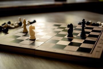 White chess knight piece and other pieces on chessboard during the game
