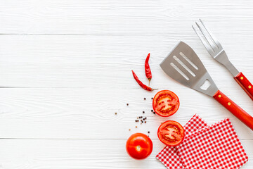 Picnic or party flatlay with barbecue utensils and vegetables, top view