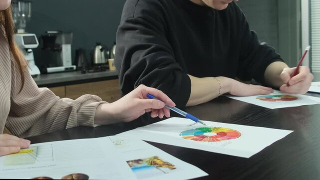 Young tasters examine palette of flavours provided on evaluation sheet. Tasting panel gives grades coffee varieties at cupping session