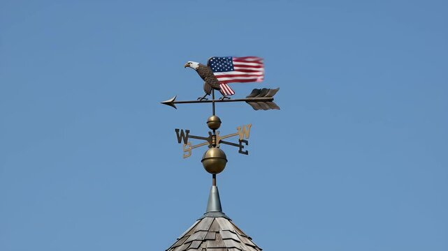 Detailed view of an eagle weather vane with american flag on a building
