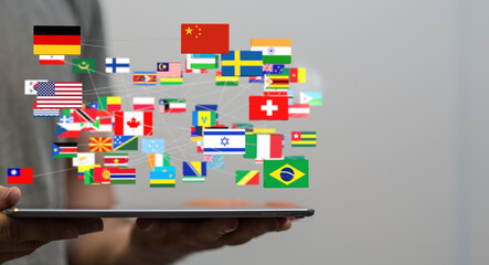 Image of many national flags interconnected, displayed on a tablet.  Represents global communication.