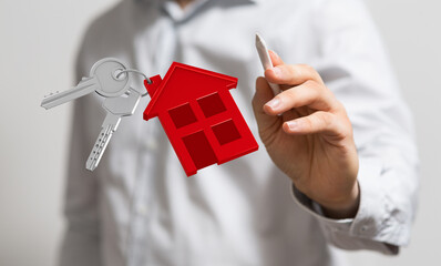 Image of a real estate agent holding house keys and a digital house keyring. Perfect for real...