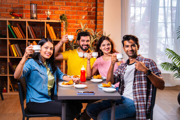 Indian youth bonding over tea, conversation in a relaxed cafe setting during a break from college