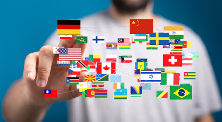Person interacts with a digital network of world flags, symbolizing global connectivity and...
