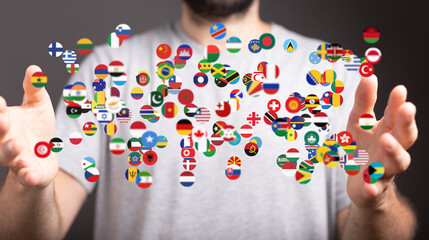 Image of a person holding numerous flags, symbolizing global connections and international...