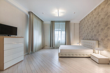 Luxury bedroom design with beautiful wall decor and parquet flooring. Light furniture, lamps on bedside tables.