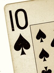 Detail of a vintage playing card in sepia on a white background.