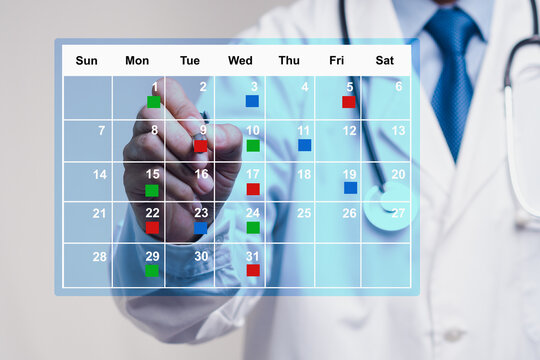 Doctor marking medical schedule on digital calendar, concept of healthcare planning and booking.