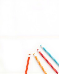Colorful striped chewing gum sticks arranged in a directional arrow shape on a clean white background, offering space for text and promoting fun flavor variety