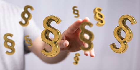 Abstract image of golden paragraph symbols floating near a hand, symbolizing legal concepts.