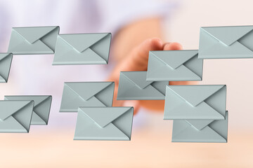 Hand interacting with floating email icons. Digital communication, inbox management.
