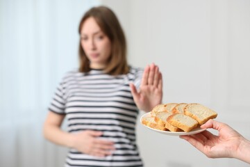 Gluten free diet. Woman refusing from bread indoors, selective focus