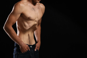 Man suffering from anorexia on black background, closeup. Space for text