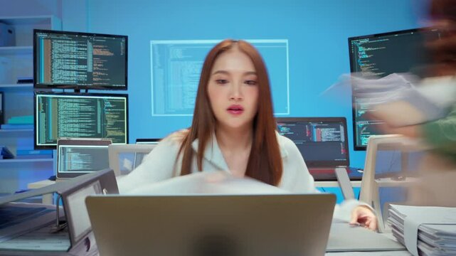 hardworking Asian businesswoman works late into the night at her home office, focused on her laptop and a stack of documents. Surrounded by papers and dim lighting, she shows signs of stress 