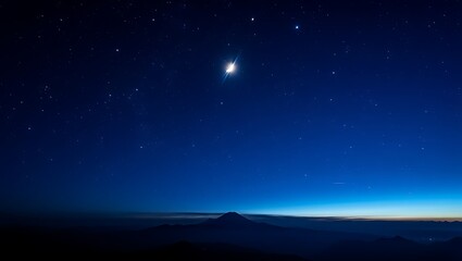 Naklejka premium Bright Star Over Mountain Landscape at Night with Deep Blue Sky