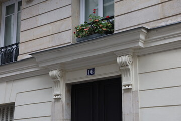 Elegant Black Parisian Doorway Number 16 with Ornate Stone Frame and Window Box