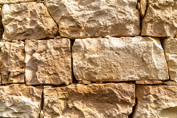 Fototapeta premium A wall made of stone with a rough texture