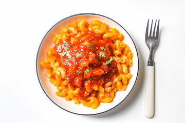 a plate of macaroni pasta with bolognese sauce and a fork, isolated on a white background