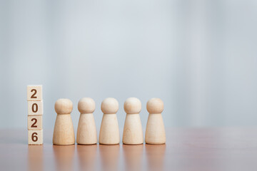 Five Wooden Figurines Standing Beside Stacked Blocks Showing '2026', Planning and Future Concept