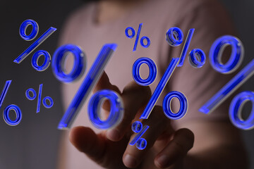 Abstract image of a person interacting with floating percentage symbols. Ideal for finance,...