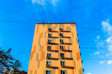 orange residential building and electric wires