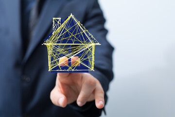 Futuristic concept of a smart home,  digital house model on a finger. Real estate, technology.