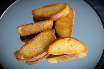 The minimal background and soft lighting highlight the golden-brown textures and natural shapes of the bread. These images are ideal for use in food branding, packaging design, editorial content