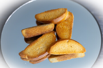 The minimal background and soft lighting highlight the golden-brown textures and natural shapes of the bread. These images are ideal for use in food branding, packaging design, editorial content