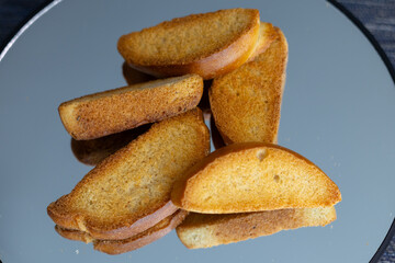 The minimal background and soft lighting highlight the golden-brown textures and natural shapes of the bread. These images are ideal for use in food branding, packaging design, editorial content