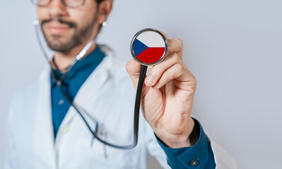 Doctor holding stethoscope with Czech Republic flag. Czech Republic health and care concept, Czech Republic flag on stethoscope