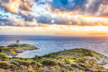Marvelous sunset view of Piscinni bay with turquoise sea and famous coastal tower of Piscinni.