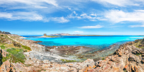 Unbelivable morning view of famous La Pelosa beach and rocky shore near Torre della Pelosa