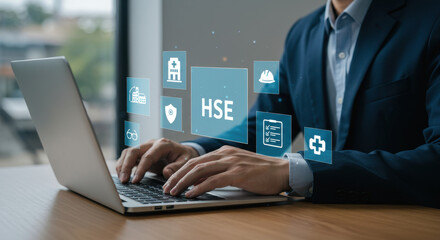 Health Safety Environment Management: Businessman uses laptop for HSE Compliance and regulations.