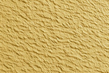 Close-up of a textured golden yellow surface with wavy patterns.