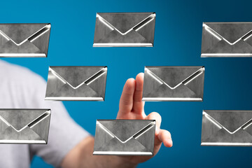 Person interacting with digital email messages, choosing one from many.
